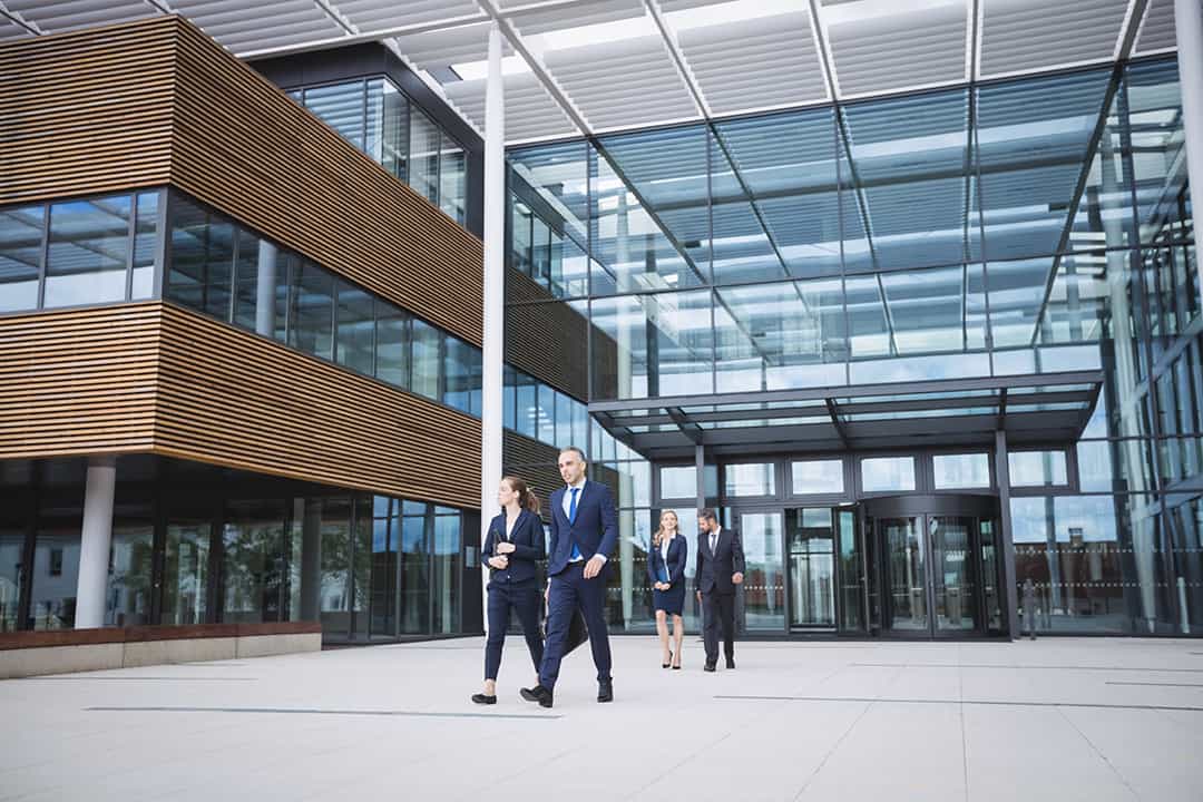 Group of business people walking outside the entrance of an office building OrthoGrap Pro with all tools needed
